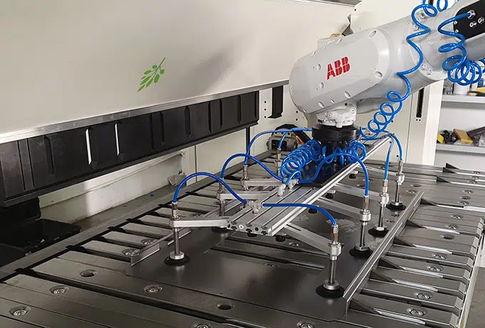 folding machine served by a robot on white background
